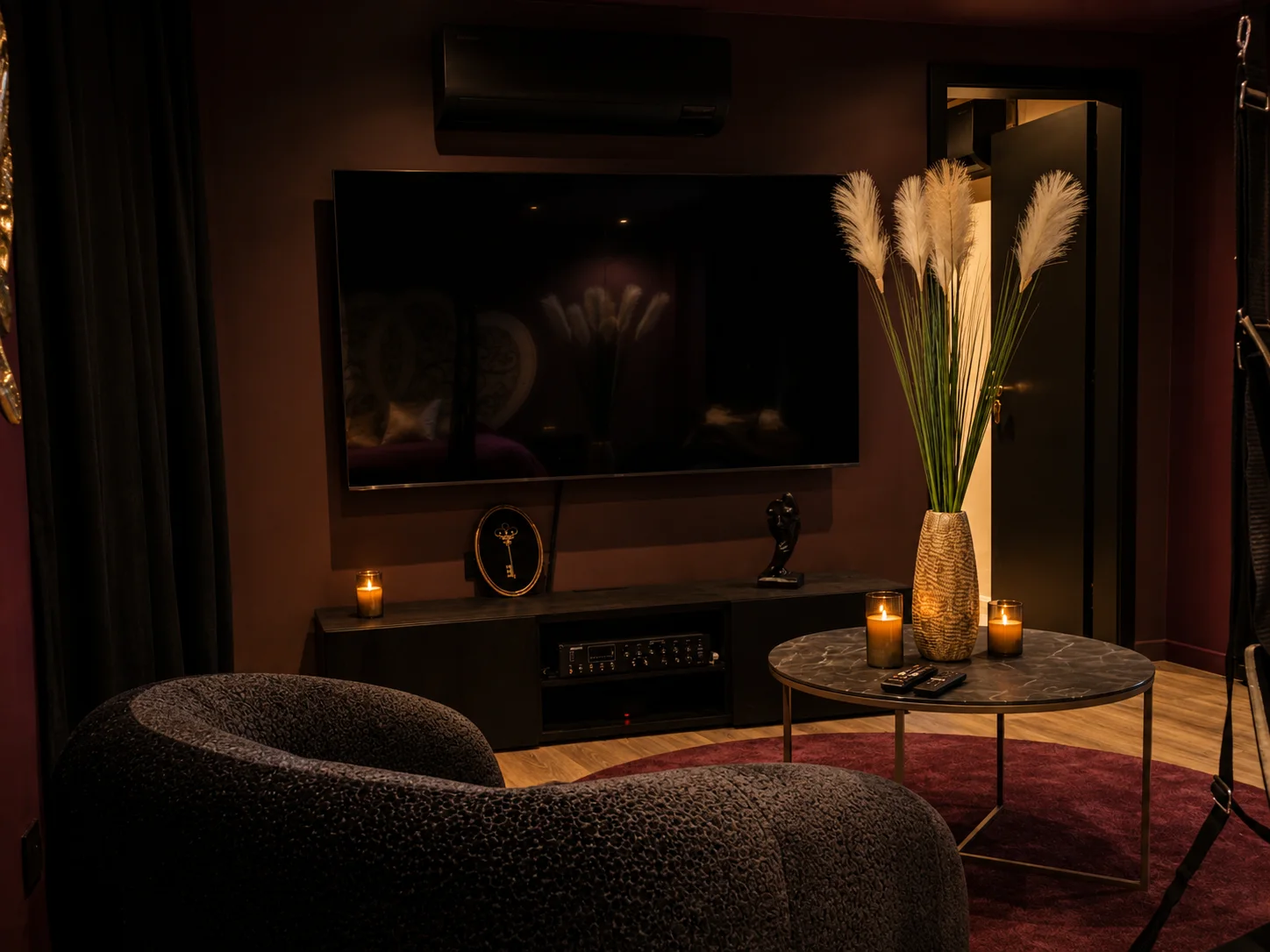 Salon avec télévision et ambiance tamisée dans la Love Room à Wissembourg